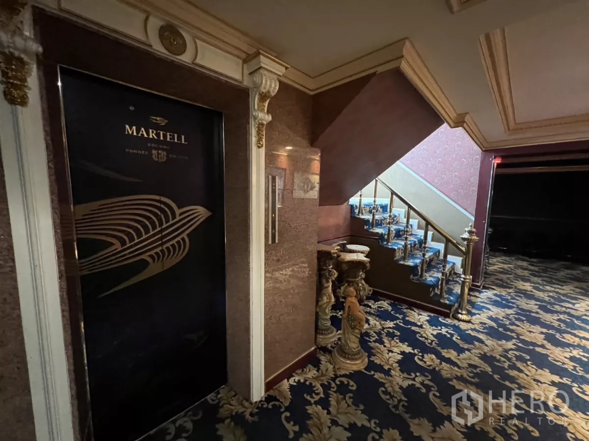 Retail Space for rent in Watthana, Bangkok - Elevator lobby beside an ornate staircase with patterned carpet.