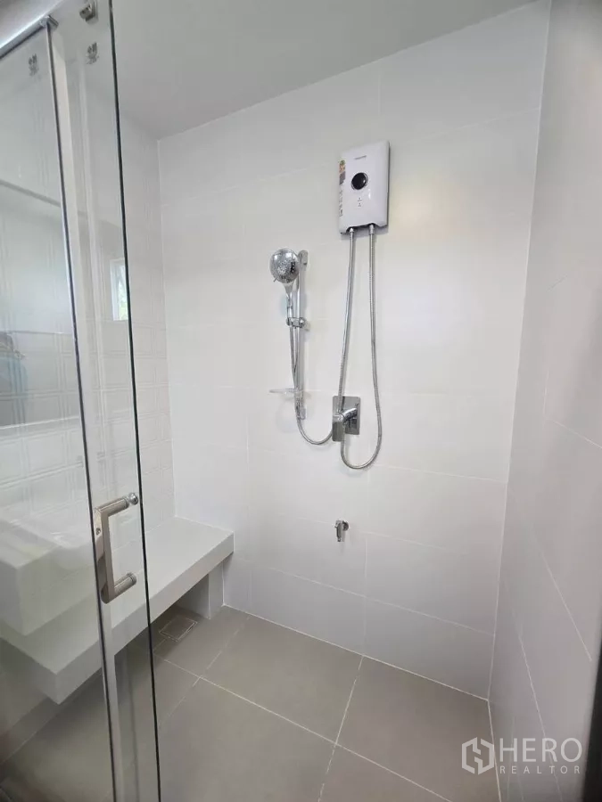 Detached House for rent in Bang Phli, Samut Prakan - Shower area with glass enclosure, bench seat and water heater.