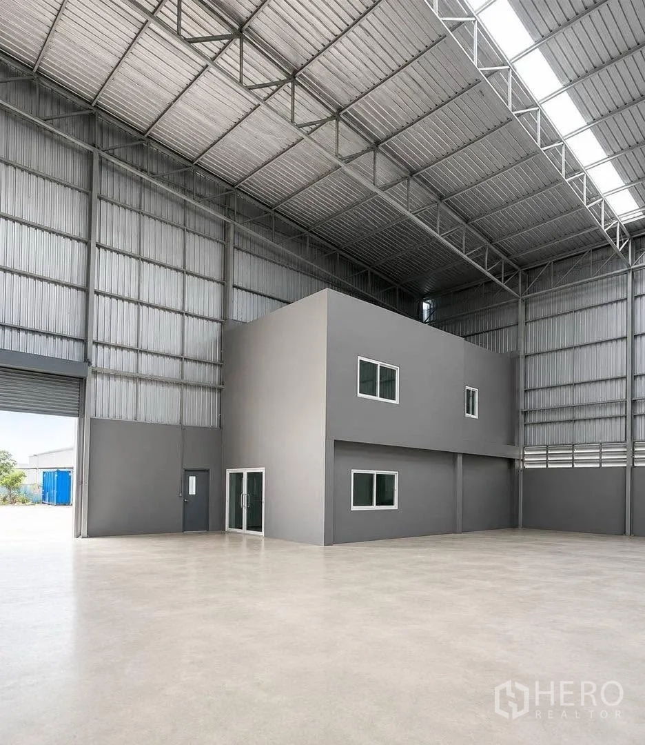 Warehouse for rent in Bang Khun Thian, Bangkok - Two-storey internal office with glass entrance and windows inside the warehouse.