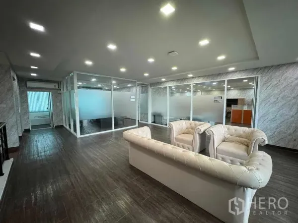 Home Office for rent or sale in Bang Phli, Samut Prakan - Reception lounge with white Chesterfield sofas and glass‑partitioned meeting rooms.