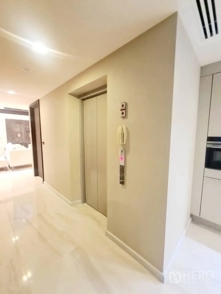 Townhouse for rent or sale in Watthana, Bangkok - In-home elevator door located off the hallway near the kitchen.