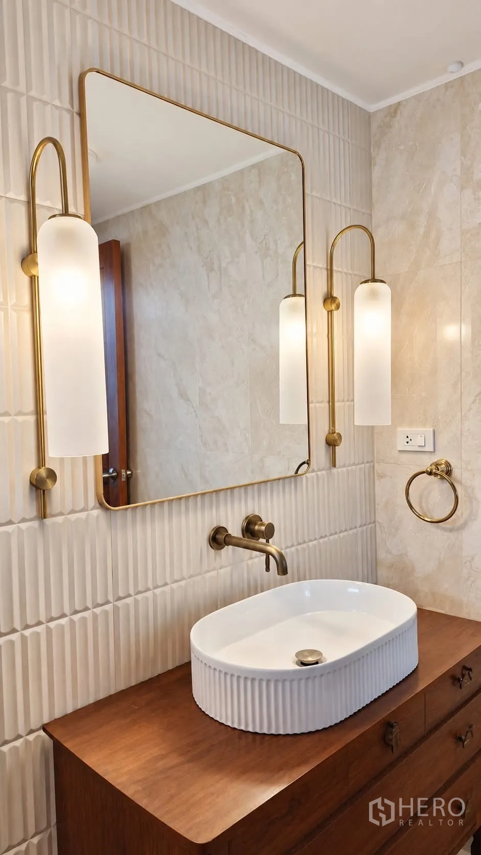 Detached House for rent in Khlong Toei, Bangkok - Stylish bathroom vanity with vessel sink, brass fixtures, and large mirror with wall sconces.
