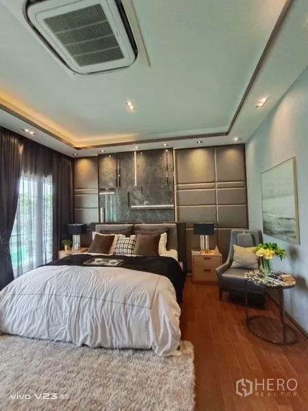 Detached House for sale in Wang Thonglang, Bangkok - Master bedroom angle showing feature wall, shag rug and side tables with lamps.