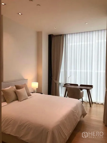 Condominium for rent - Master bedroom with desk by the window, soft lighting and sheer curtains.