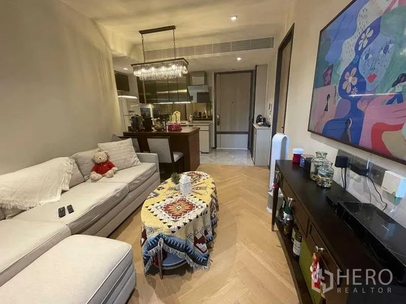 Condominium for rent or sale - Cozy living room with sofa adjoining kitchen and breakfast island