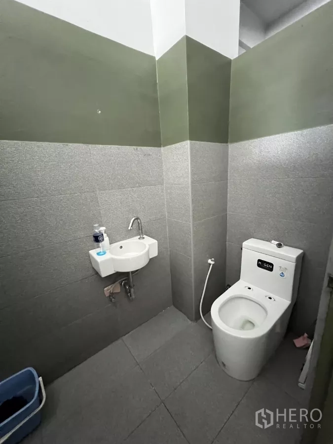 店屋 出租在Watthana, Bangkok - 翻新卫生间，双色瓷砖、坐便器与角落洗手盆。