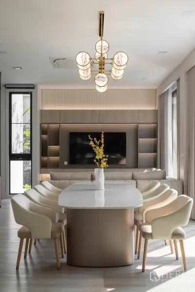 Detached House for rent in Saphan Sung, Bangkok - Dining table facing TV wall and sofa in a contemporary neutral lounge.