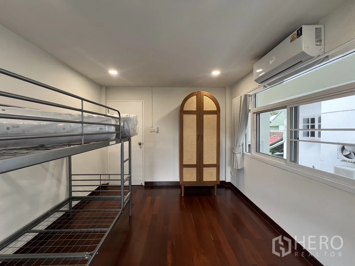 Detached House for rent in Saphan Sung, Bangkok - Third bedroom angle showing bunk bed and long window with curtains.