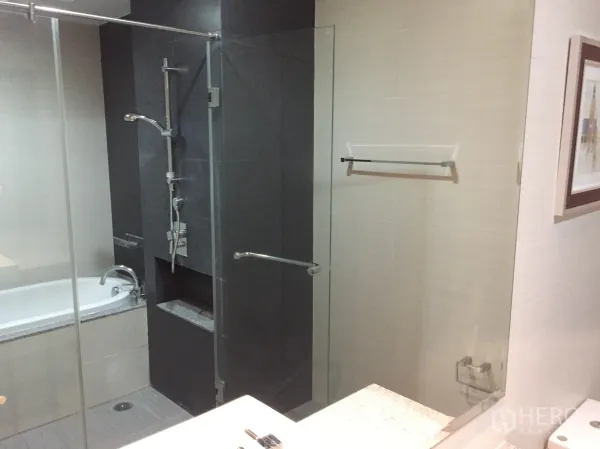 คอนโด ให้เช่าในKhlong Toei, Bangkok - ห้องน้ำสมัยใหม่พร้อมตู้อาบน้ำกระจกข้างอ่างอาบน้ำ ผนังโทนเข้มและชุดก๊อกน้ำหรู