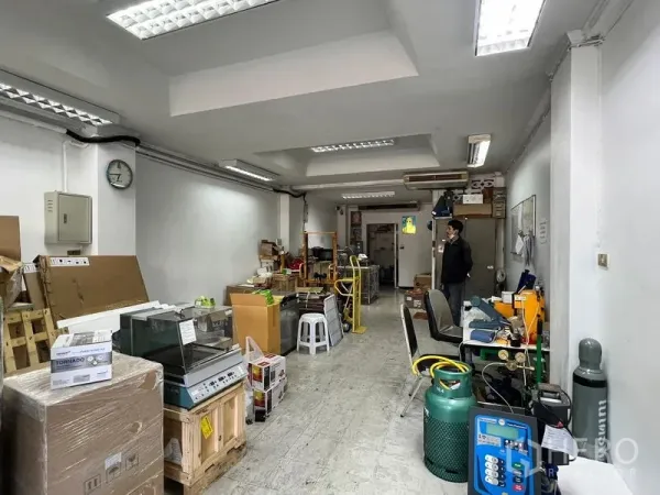 店屋 出租在Watthana, Bangkok - 店内开敞式空间，白色墙面与明亮灯光，耐用地面及工作与储物区，适合咖啡馆或零售，位于曼谷通罗。