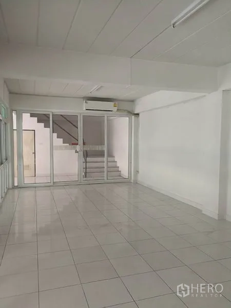 Warehouse for rent in Bang Phli, Samut Prakan - Clean office room with glass wall and staircase access within the warehouse complex.