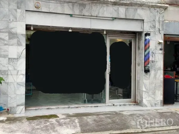 Townhouse for sale in Bang Phlat, Bangkok - Townhouse street-level facade with marble cladding and a sliding glass door shopfront.