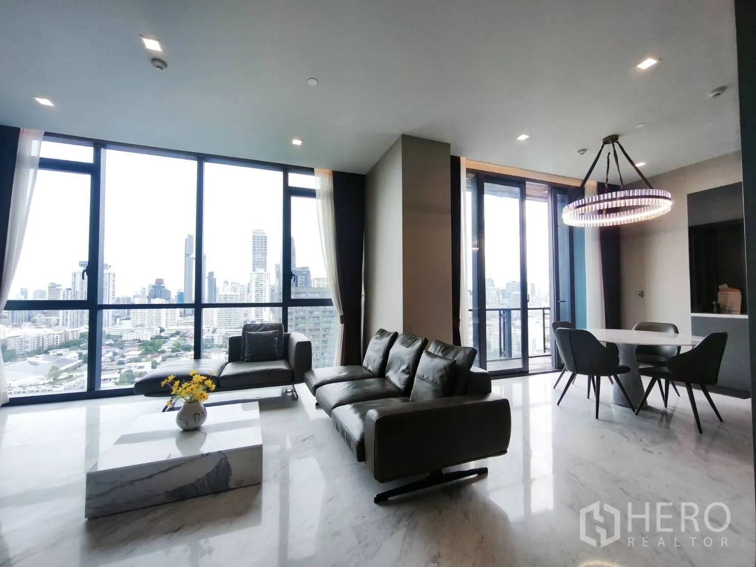 Condominium for rent in Watthana, Bangkok - Open living and dining room with floor-to-ceiling windows.