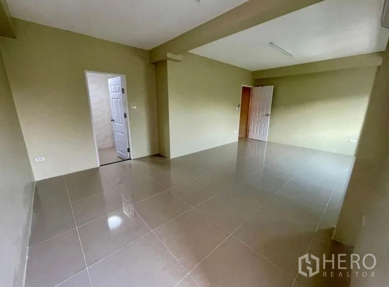 Townhouse for rent - Spacious bedroom with tiled flooring and ensuite bathroom access.