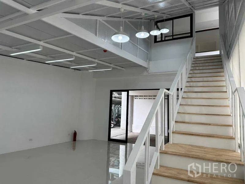 Office Space for rent or sale in Khlong Toei, Bangkok - Ground floor area with staircase, glass door entry and bright natural light.