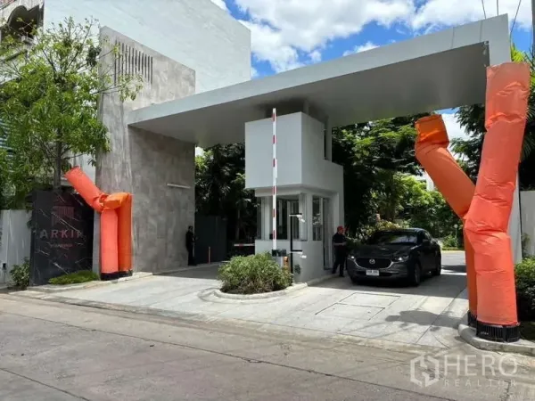 Townhouse for rent or sale in Don Mueang, Bangkok - Gated community entrance with security booth, barrier and ARKIN signage.
