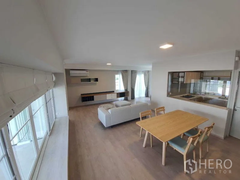 Townhouse for rent - Wide view of open living and dining with pass-through window to the kitchen.