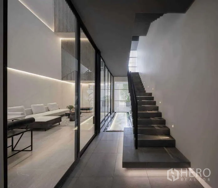 Home Office for rent in Bang Phli, Samut Prakan - Corridor with floating staircase, glass partition and subtle step lighting.