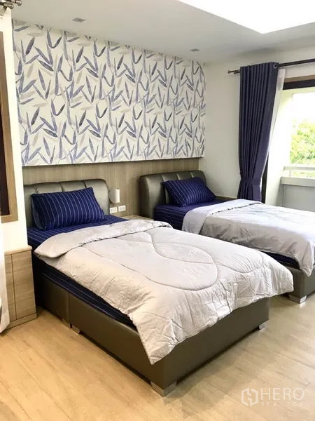 公寓 出租在Watthana, Bangkok - 次卧两张单人床，装饰墙板与落地窗帘