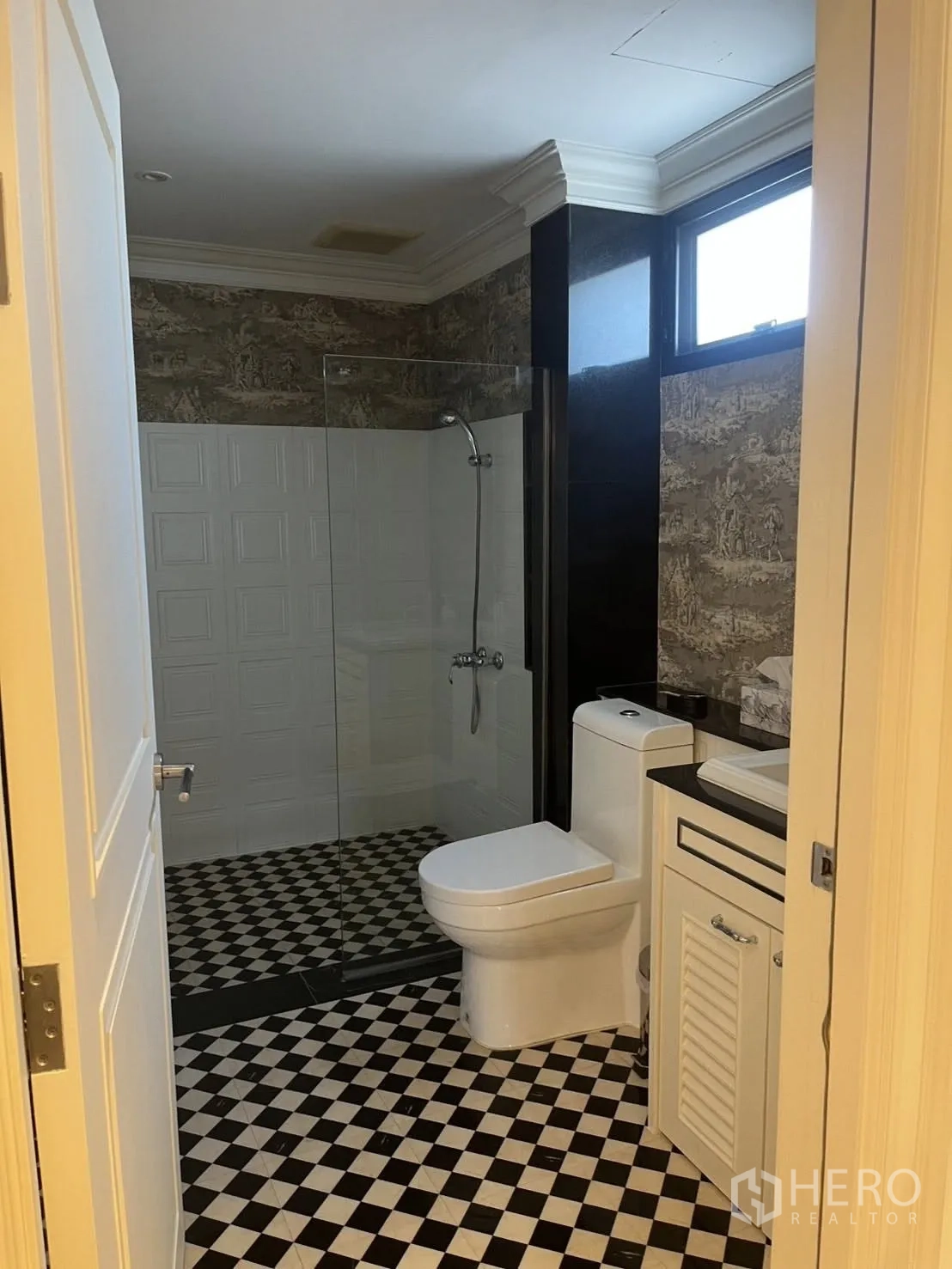Home Office for rent in Watthana, Bangkok - Bathroom with glass shower, checkered tile floor, and vanity.