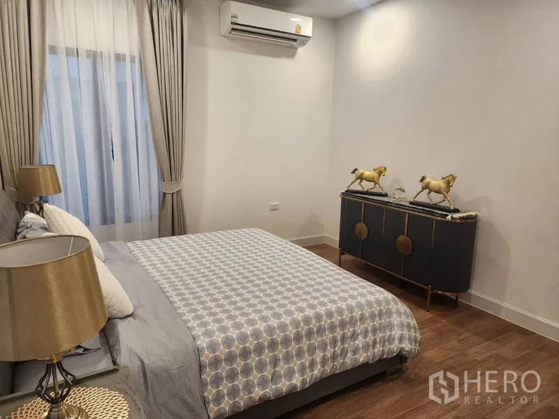 Detached House for rent or sale - Bedroom angle showing bed, gold-accented dresser and soft ambient lighting