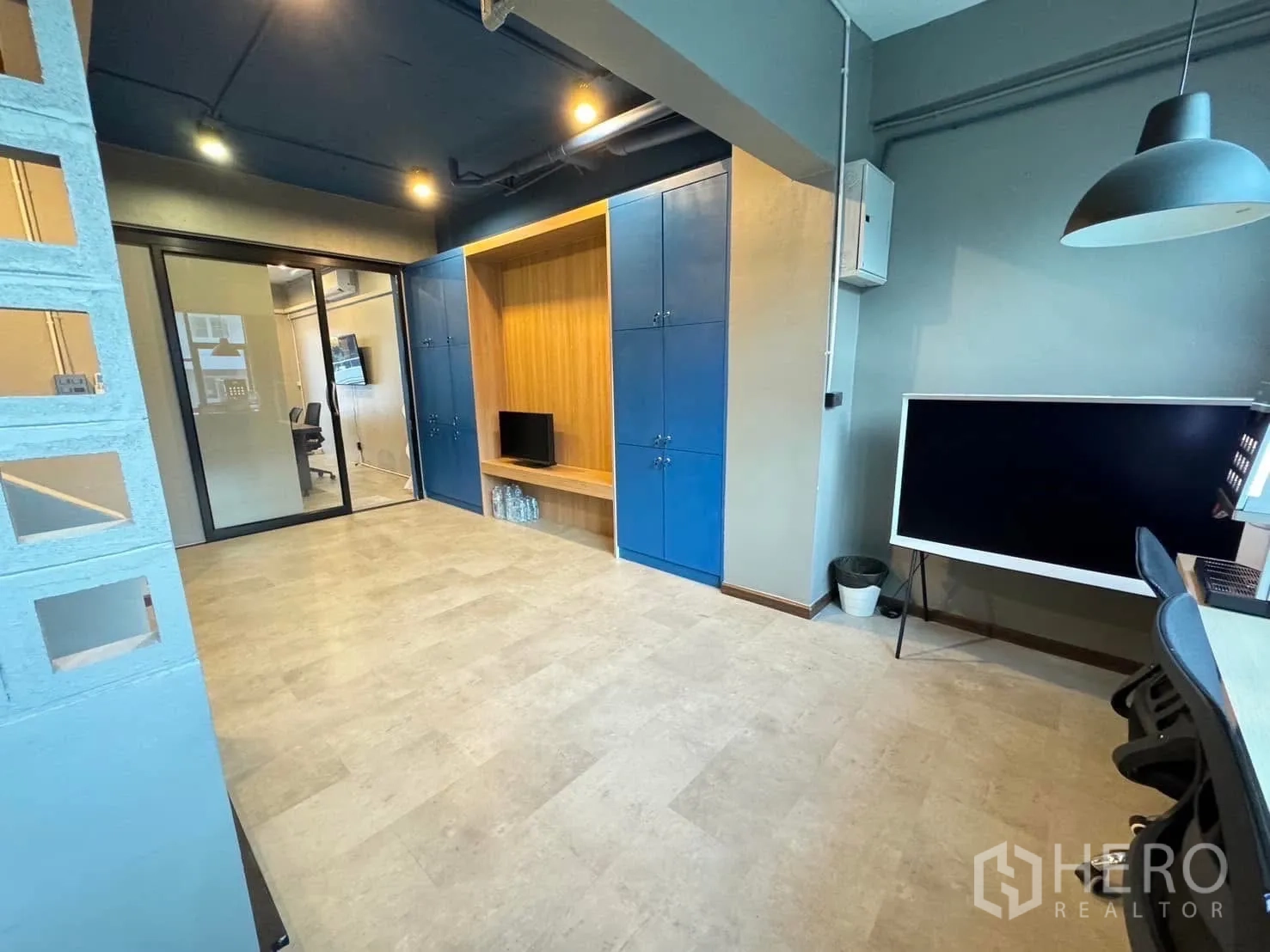 家庭办公室 for rent in Watthana, Bangkok - 开放式办公区，内置蓝色储物柜与玻璃推拉门。