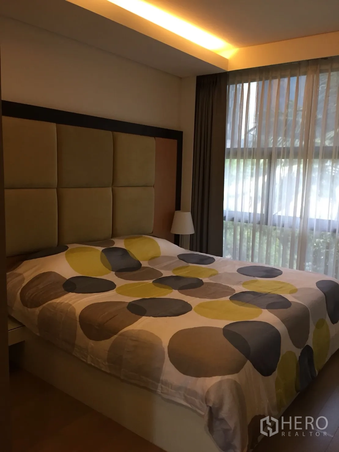 Condominium for rent in Watthana, Bangkok - Second bedroom with large window, sheer curtains and upholstered headboard.