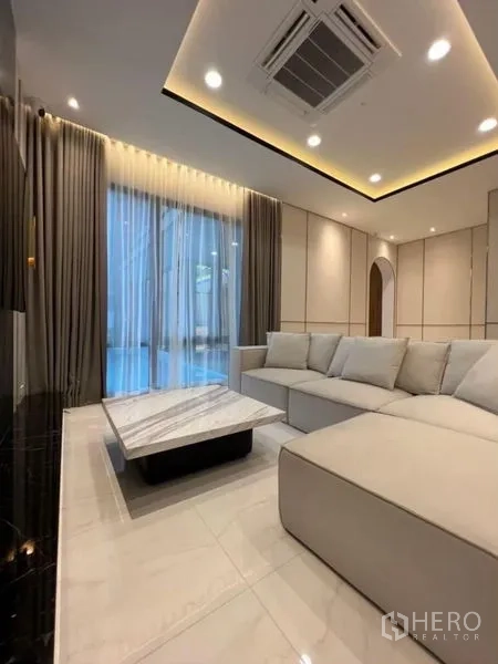 Detached House for rent - Second living area with a marble coffee table beside full-height curtains.