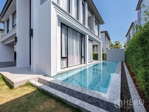Detached House for sale in Prawet, Bangkok - Private lap pool along the side garden with stone steps and hedge privacy.