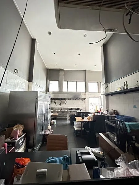 Retail Space for rent in Suan Luang, Bangkok - Commercial kitchen with high ceiling, stainless appliances, prep stations, windows and wall shelving.