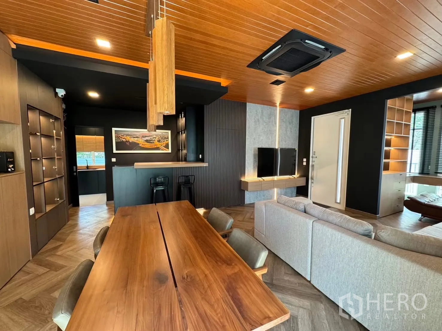 独栋房屋 for rent in Prawet, Bangkok - 客餐厅铺人字拼地板，推拉门通向庭院。