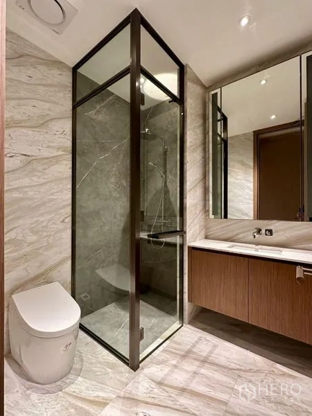 Condominium for rent or sale - Guest bathroom with glass-enclosed shower and sleek vanity.