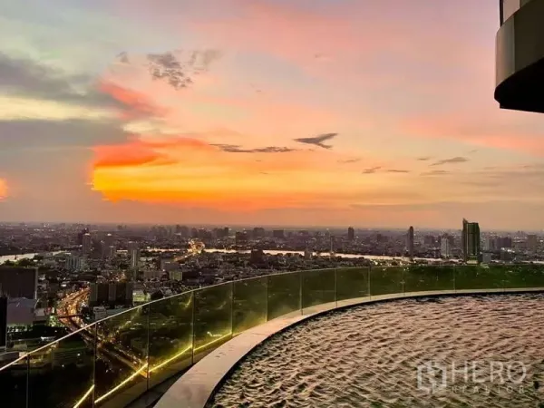 Condominium for rent or sale in Bangkok - Rooftop infinity-edge pool with panoramic Bangkok skyline at dusk.