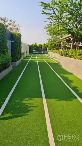Condominium for rent in Phra Khanong, Bangkok - Condo outdoor jogging track with artificial turf and shaded trees in Bang Chak.