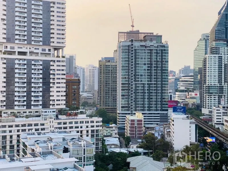 Condominium for sale - High-floor city skyline near Thonglor with BTS track visible between towers.