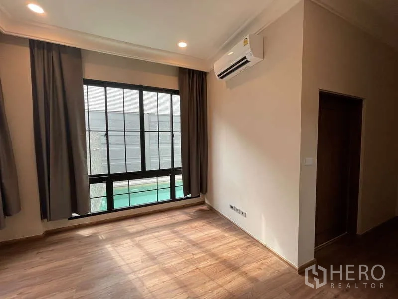 Detached House for sale in Thawi Watthana, Bangkok - Bedroom with wood floors, large windows, blackout curtains and pool view