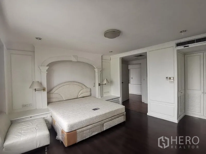 Condominium for rent in Watthana, Bangkok - Bright master bedroom showing integrated wardrobes and bedside lighting.