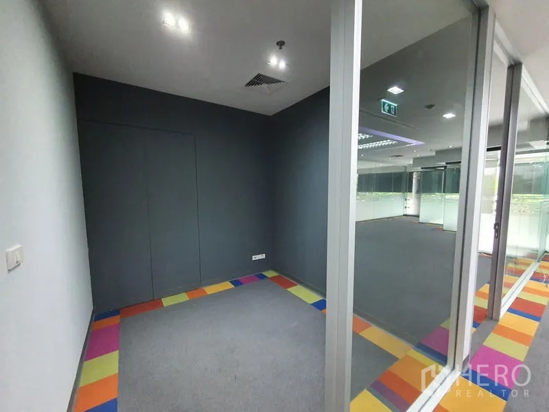 Office Space for rent in Watthana, Bangkok - Compact private room with grey wall and glass partition facing the open office.