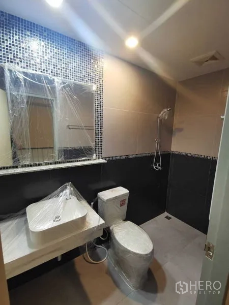 Home Office for rent or sale - Modern bathroom with shower, vanity, and mosaic tile feature wall.
