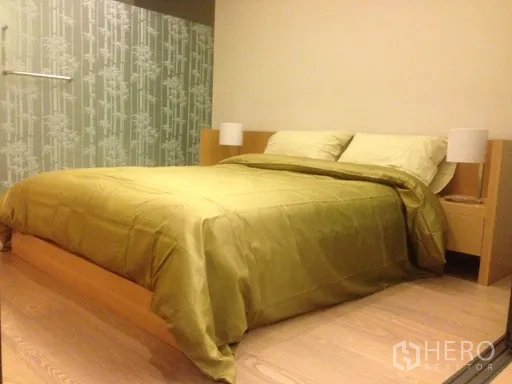 Condominium for rent or sale in Watthana, Bangkok - Bedroom with double bed, soft lighting and a patterned feature wall