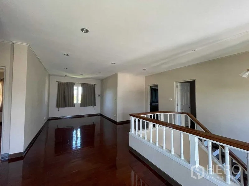 Detached House for sale in Bang Bon, Bangkok - Upper landing area with wooden handrail and recessed ceiling lights