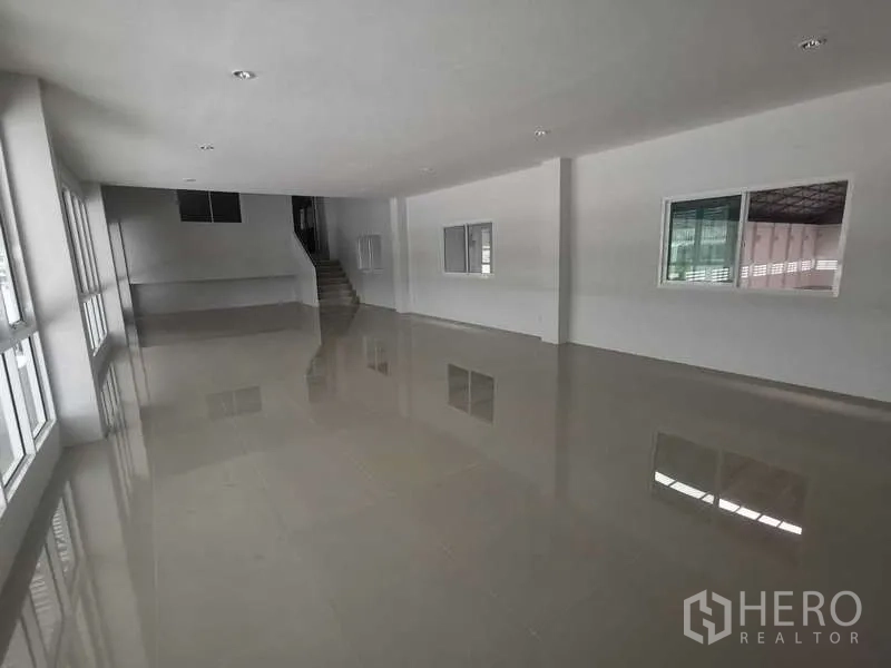 Factory for rent or sale in Bang Bo, Samut Prakan - Bright upstairs office space with large windows and glossy tiled flooring.