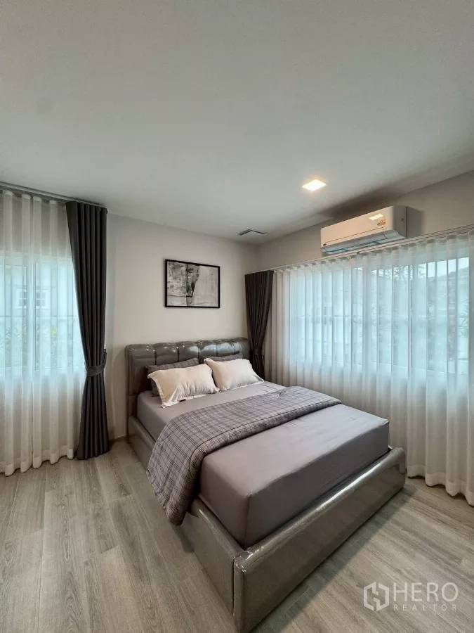 Detached House for rent in Bang Phli, Samut Prakan - Corner bedroom with large windows, sheer curtains and a queen bed