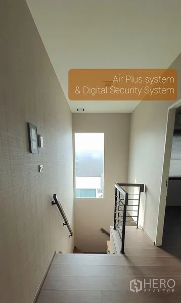 Detached House for rent in Bang Phli, Samut Prakan - Staircase landing with window and slim metal handrail against neutral walls