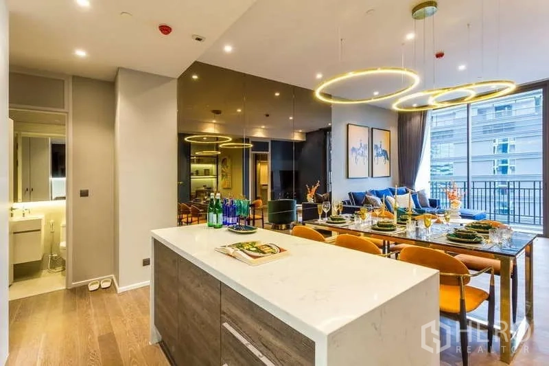 Condominium for rent in Pathum Wan, Bangkok - Kitchen island facing dining and living area toward the balcony.
