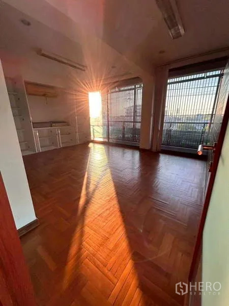 Home Office for rent or sale in Bang Phli, Samut Prakan - Office room at sunset with blinds, built-in cabinet and warm light on parquet floor.