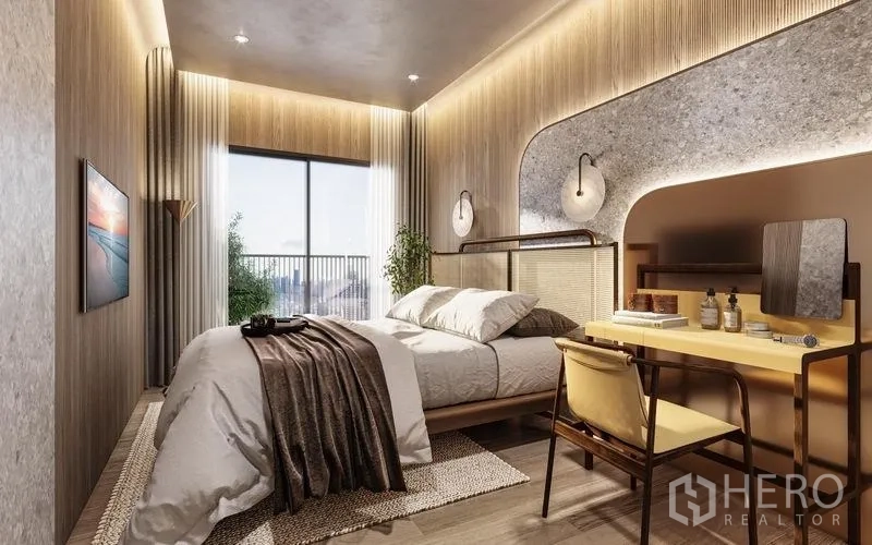 Condominium for sale in Khlong Toei, Bangkok - Warmly lit bedroom with built-in desk, contemporary lighting, and a large window with city view.