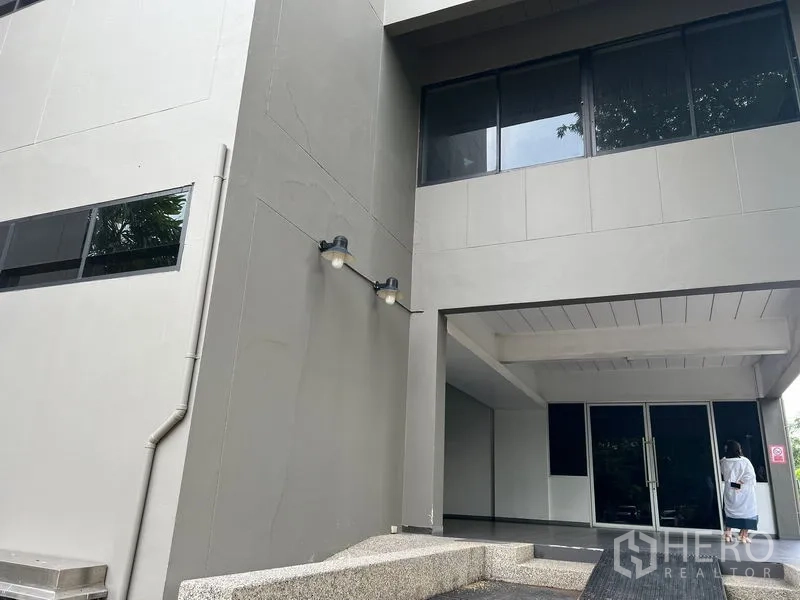Office Space for rent in Mueang Samut Prakan, Samut Prakan - Modern office building entrance canopy with glass doors.