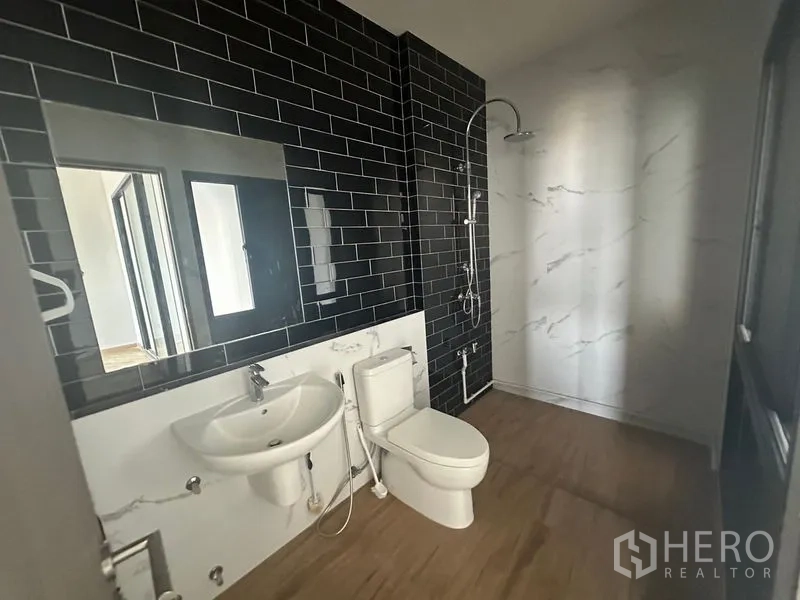 Home Office for rent - Contemporary bathroom featuring black subway tiles and a walk-in shower.