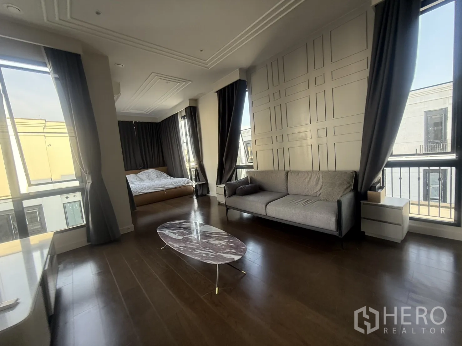 Detached House for rent in Saphan Sung, Bangkok - Large suite combining bedroom and lounge with sofa, big windows and wood floors.